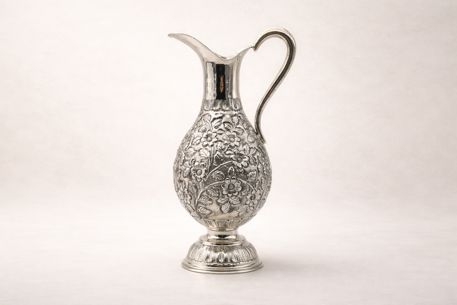 Silver-plated pitcher with hand-engraved floral artisan detailing, handcrafted in Istanbul's Grand Bazaar